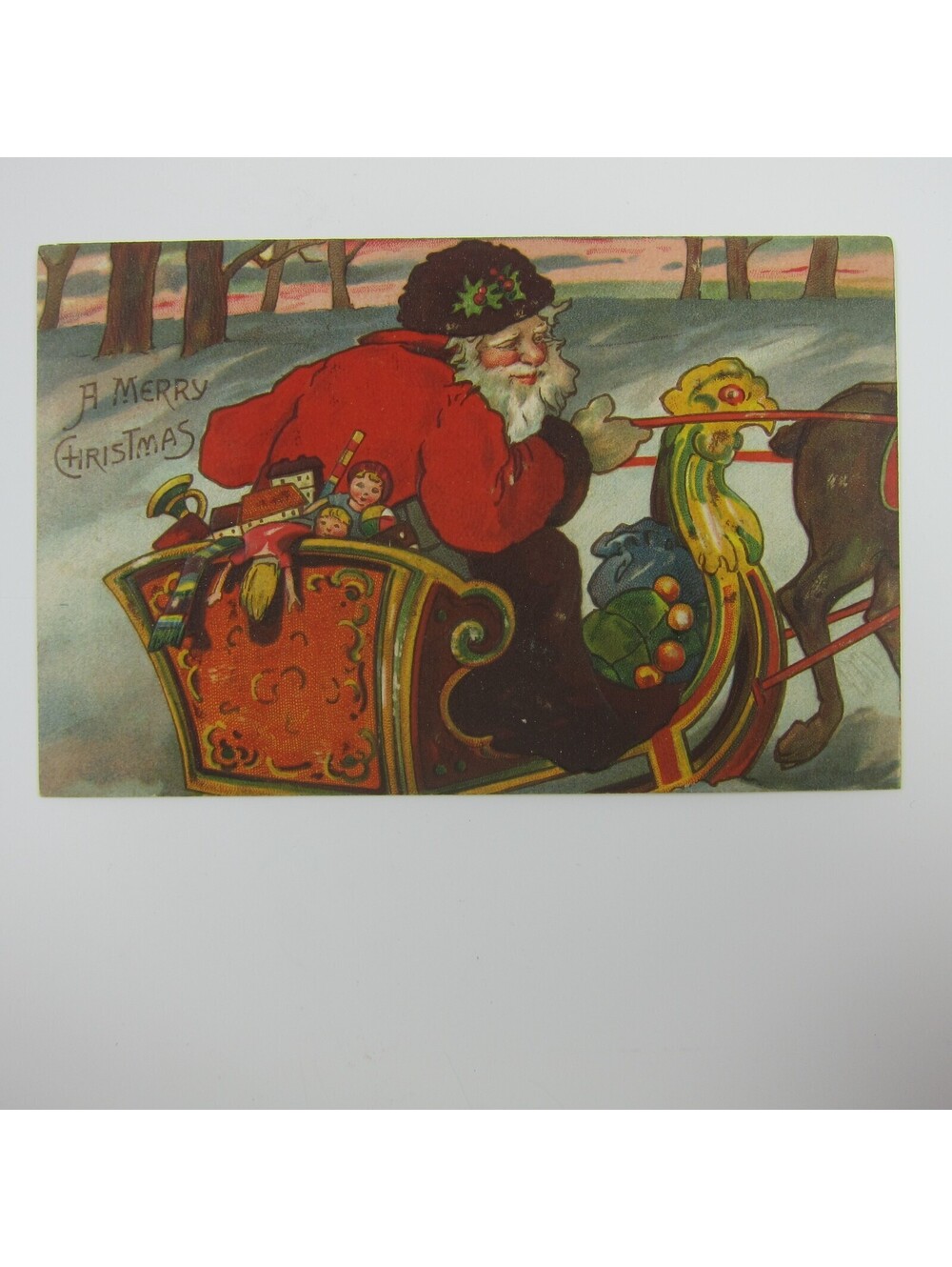 Vintage Christmas Postcard Santa Rides Sleigh Toys Snow Trees Embossed Antique